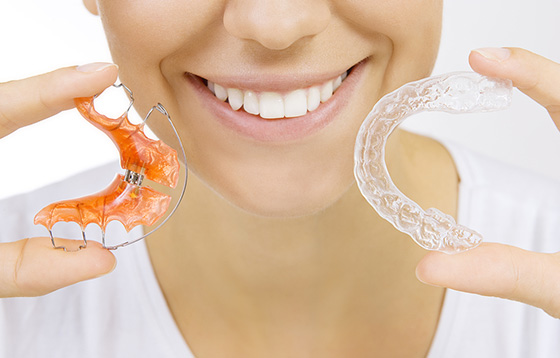 woman with retainers in hand