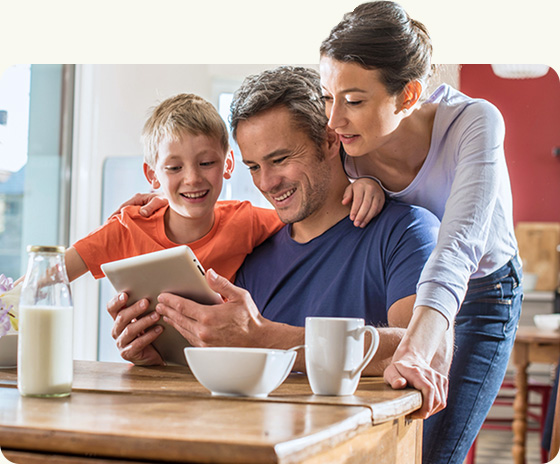 Family Smiling at Tablet