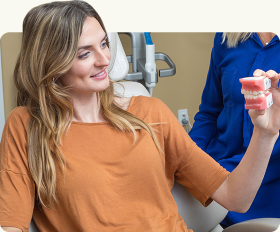 Patient holding dental model