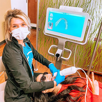 Dr. Cronin scanning patient's teeth